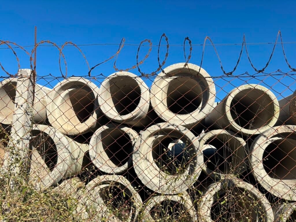 Tubulação de concreto da Sabesp armazenada no acampamento da concessionária, em Cumbica